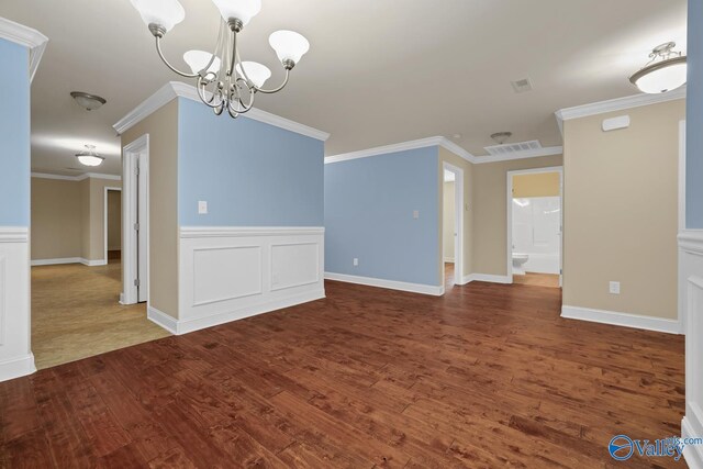 164 Moore Farm Cir NW, Huntsville, AL 35806 - unfurnished dining area featuring an inviting chandelier, ornamental molding, wood finished floors, and visible vents