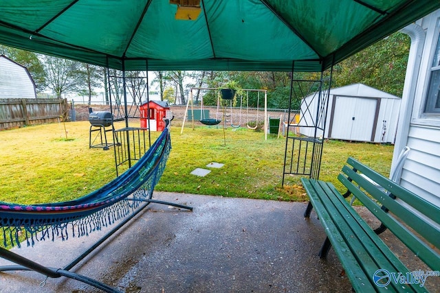 view of patio / terrace featuring a storage shed and a playground