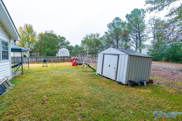 view of yard with a storage unit and a playground