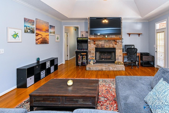 living room with a tray ceiling, crown molding, and wood finished floors