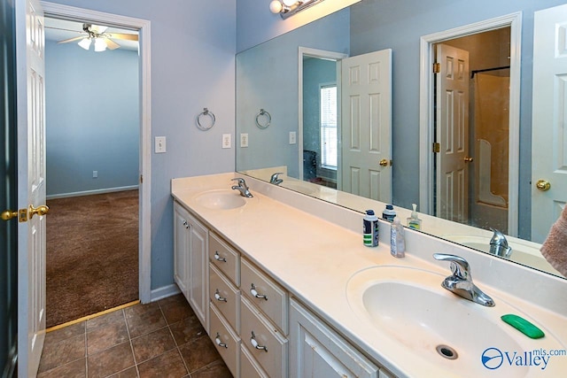 full bath featuring a shower with shower door, a sink, and double vanity