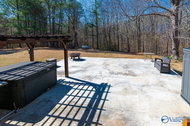 view of patio / terrace with a forest view and an outdoor fire pit