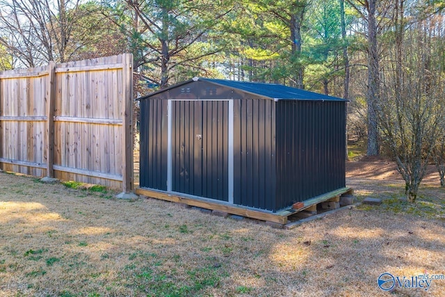 view of shed with fence