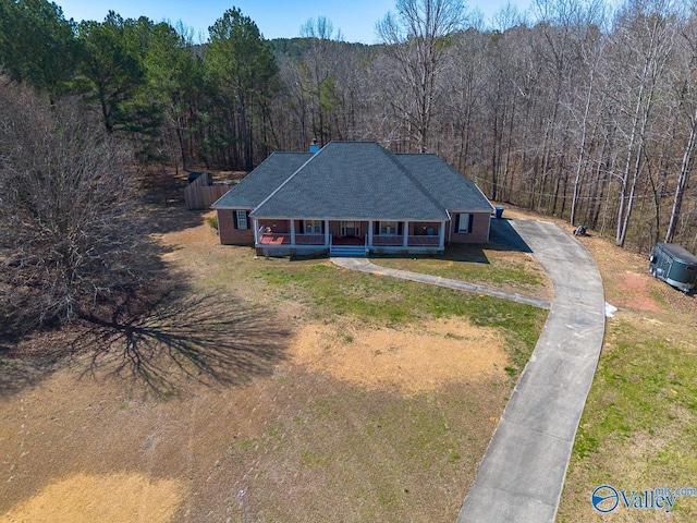 bird's eye view with a wooded view