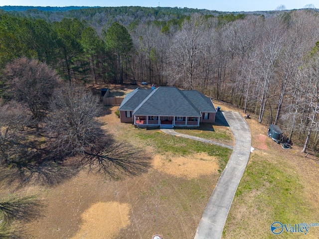 bird's eye view with a wooded view