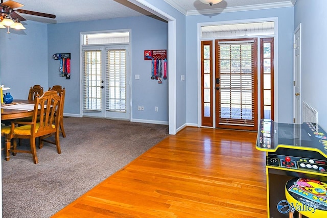 entryway with ornamental molding, french doors, carpet flooring, and baseboards