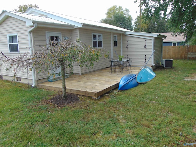 back of house featuring a wooden deck, cooling unit, and a yard