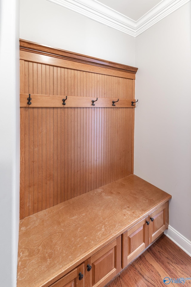 mudroom with light wood-type flooring and crown molding