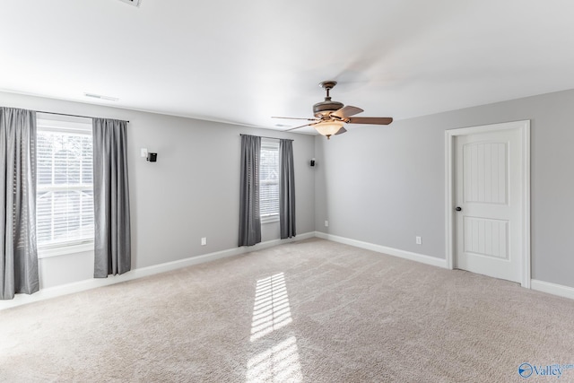 carpeted empty room featuring ceiling fan