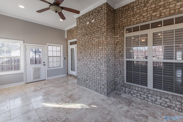 unfurnished sunroom with ceiling fan