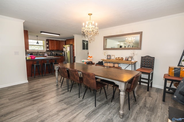 dining area featuring a notable chandelier, ornamental molding, and dark hardwood / wood-style flooring