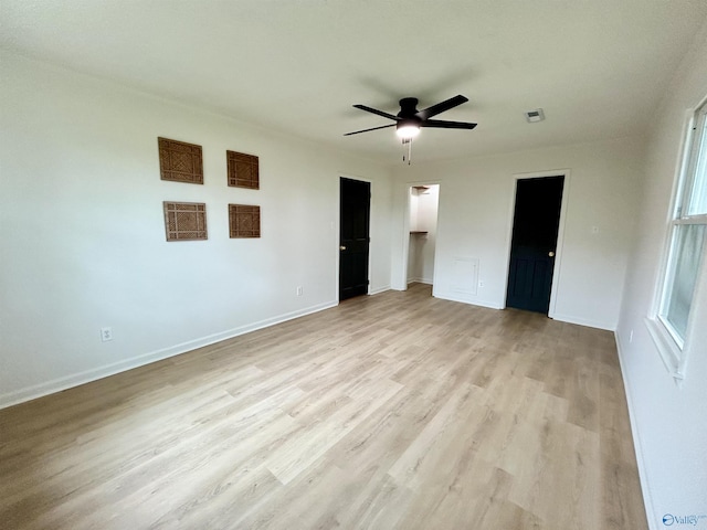 2704 Mctavish Ave SW, Decatur, AL 35603 - unfurnished bedroom with light wood finished floors, baseboards, a ceiling fan, and a spacious closet