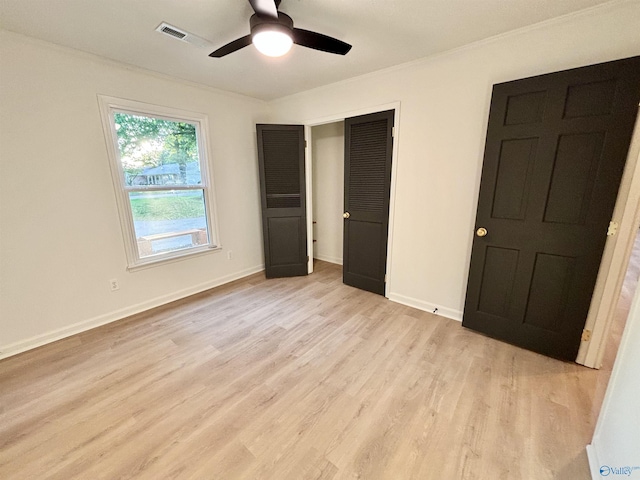 2704 Mctavish Ave SW, Decatur, AL 35603 - unfurnished bedroom with light wood-type flooring, a closet, ornamental molding, baseboards, and a ceiling fan