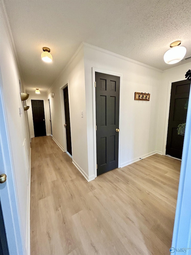 2704 Mctavish Ave SW, Decatur, AL 35603 - entryway with light wood-style floors, a textured ceiling, ornamental molding, and baseboards