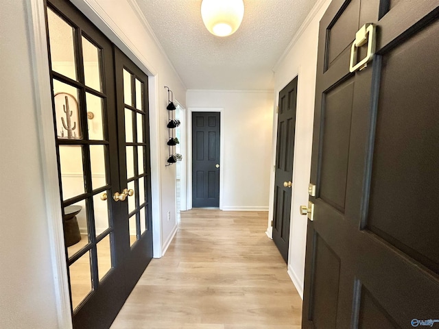 2704 Mctavish Ave SW, Decatur, AL 35603 - foyer with french doors, a textured ceiling, light wood finished floors, and baseboards