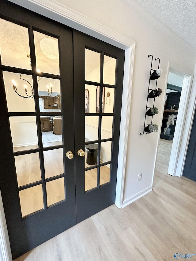 2704 Mctavish Ave SW, Decatur, AL 35603 - detailed view of french doors, wood finished floors, a textured ceiling, and baseboards