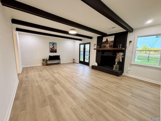 2704 Mctavish Ave SW, Decatur, AL 35603 - unfurnished living room with baseboards, wood finished floors, beamed ceiling, and a brick fireplace