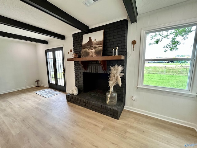 2704 Mctavish Ave SW, Decatur, AL 35603 - unfurnished living room featuring baseboards, wood finished floors, beamed ceiling, and a fireplace