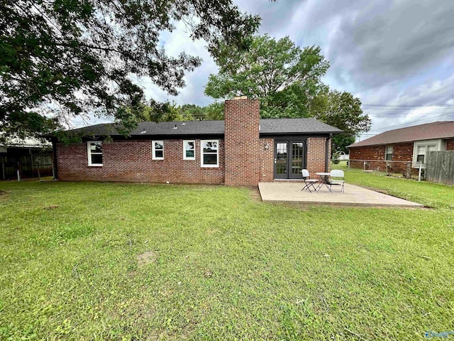 2704 Mctavish Ave SW, Decatur, AL 35603 - rear view of house featuring a patio area, brick siding, a chimney, and french doors