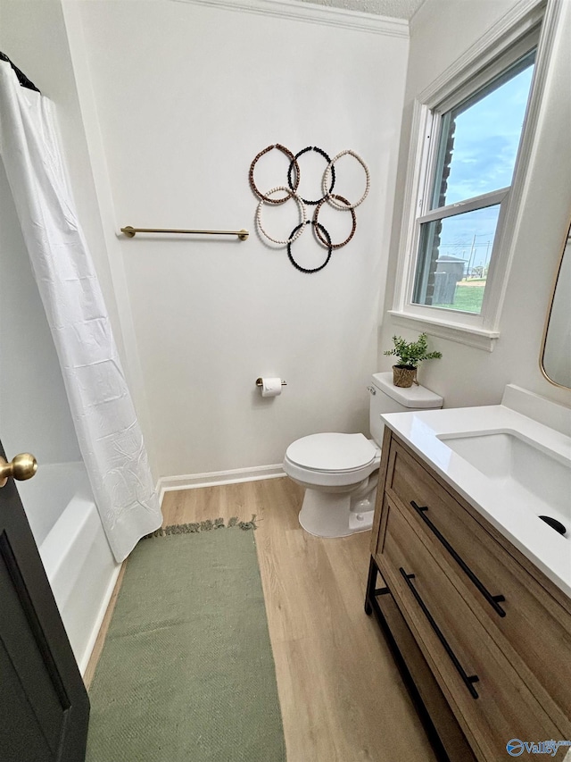 2704 Mctavish Ave SW, Decatur, AL 35603 - bathroom with wood finished floors, vanity, toilet, shower / bathtub combination with curtain, and baseboards