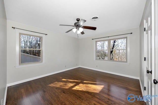 unfurnished room with dark hardwood / wood-style flooring and ceiling fan