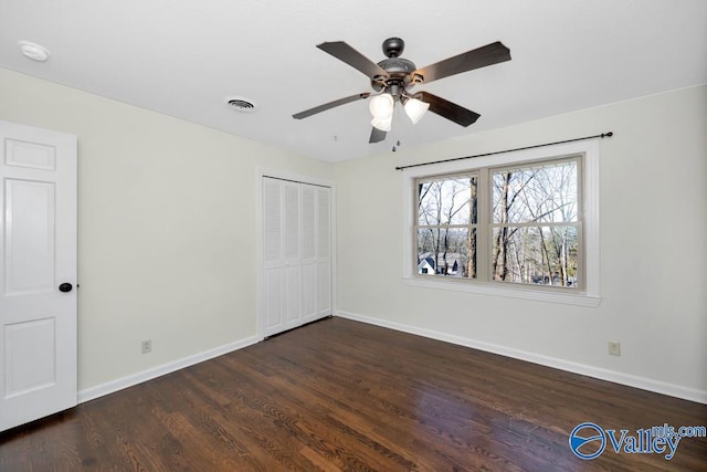 unfurnished bedroom featuring ceiling fan, dark hardwood / wood-style floors, and a closet