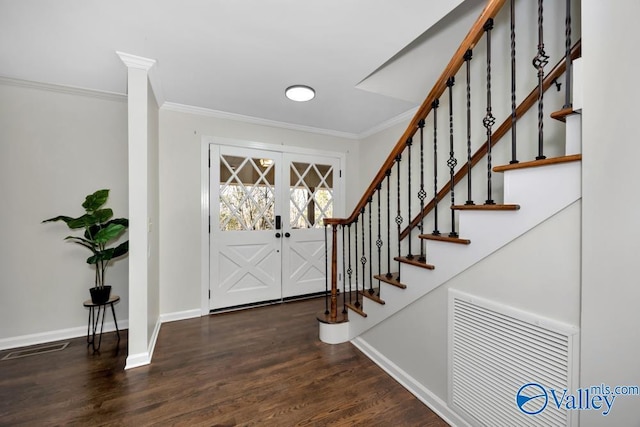 entryway with french doors, ornamental molding, and dark hardwood / wood-style flooring