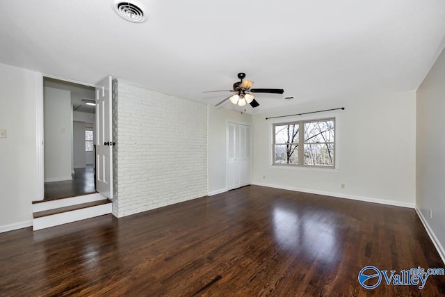 spare room with dark hardwood / wood-style floors and ceiling fan