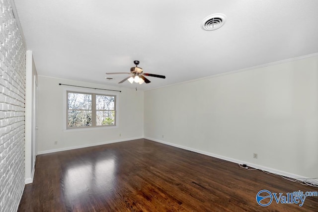 spare room with crown molding, ceiling fan, and dark hardwood / wood-style flooring