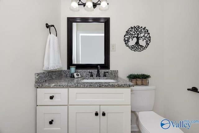 bathroom featuring vanity and toilet