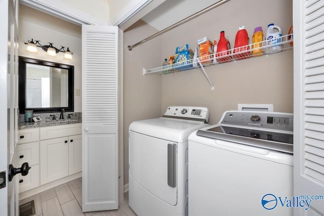 washroom featuring sink and washer and dryer