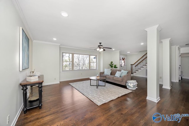 living room featuring dark wood-type flooring, ornamental molding, decorative columns, and ceiling fan