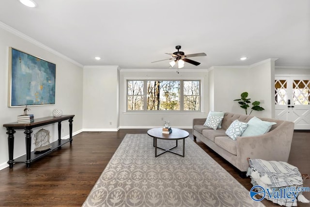 living room with ornamental molding, dark wood-type flooring, and ceiling fan