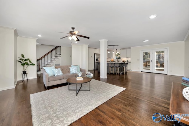 living room featuring crown molding, ceiling fan, dark hardwood / wood-style flooring, and french doors