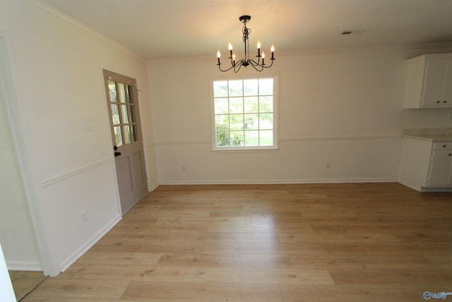233 Shaw Rd NW, Hartselle, AL 35640 - unfurnished dining area with a chandelier, ornamental molding, light wood-type flooring, and baseboards