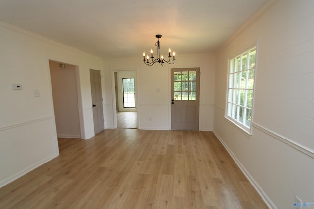 233 Shaw Rd NW, Hartselle, AL 35640 - unfurnished dining area featuring a chandelier, light wood-type flooring, crown molding, and baseboards