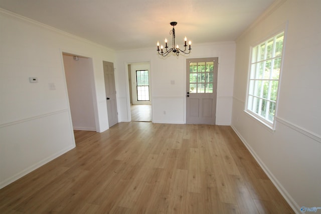 233 Shaw Rd NW, Hartselle, AL 35640 - unfurnished dining area featuring a chandelier, light wood finished floors, ornamental molding, and baseboards