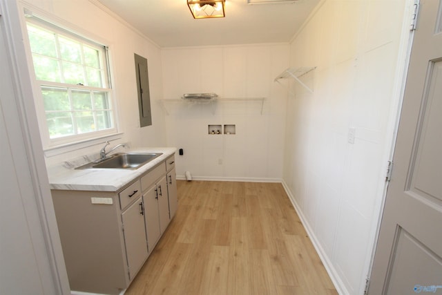 233 Shaw Rd NW, Hartselle, AL 35640 - washroom featuring hookup for a washing machine, electric panel, light wood-style floors, cabinet space, and crown molding