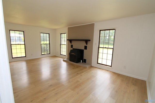 233 Shaw Rd NW, Hartselle, AL 35640 - unfurnished living room featuring light wood-style floors, baseboards, and a fireplace