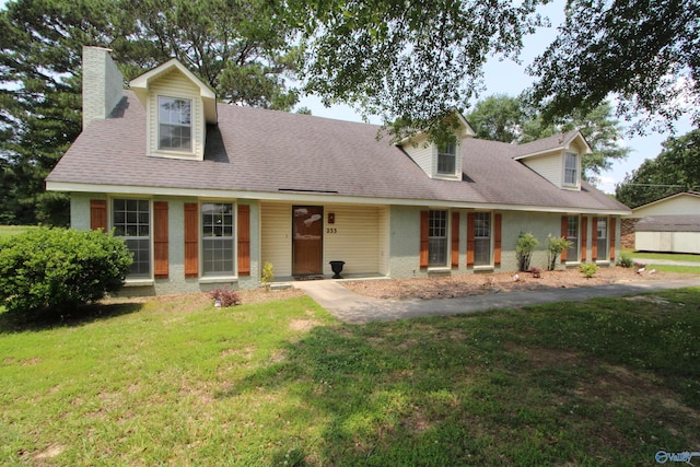 233 Shaw Rd NW, Hartselle, AL 35640 - cape cod-style house featuring a chimney and a front yard