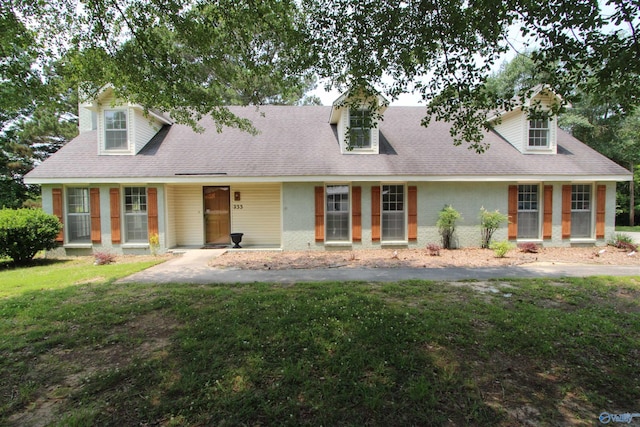 233 Shaw Rd NW, Hartselle, AL 35640 - cape cod house featuring a front lawn, brick siding, and roof with shingles