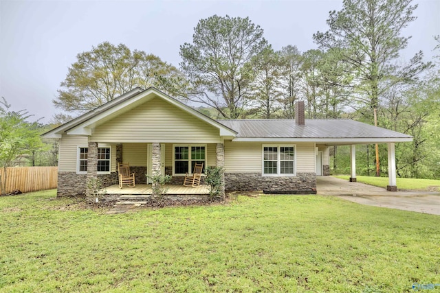 single story home featuring driveway, stone siding, and a front lawn