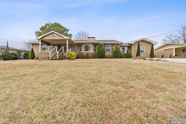 ranch-style home with covered porch and a front lawn