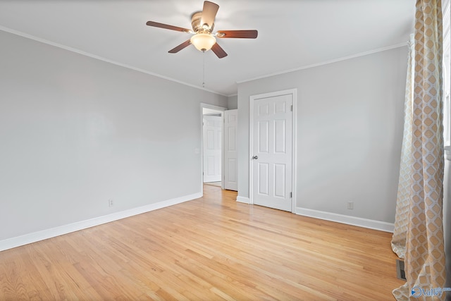 spare room with ornamental molding, ceiling fan, and light wood-type flooring