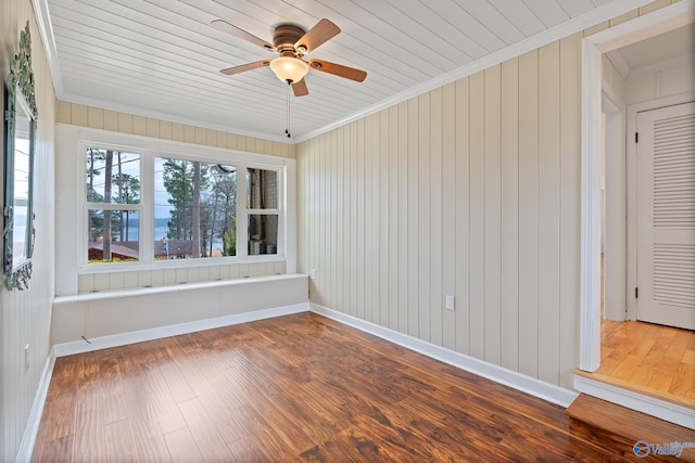 unfurnished room featuring hardwood / wood-style floors, ornamental molding, and ceiling fan