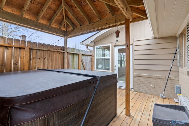 deck with a hot tub and a gazebo