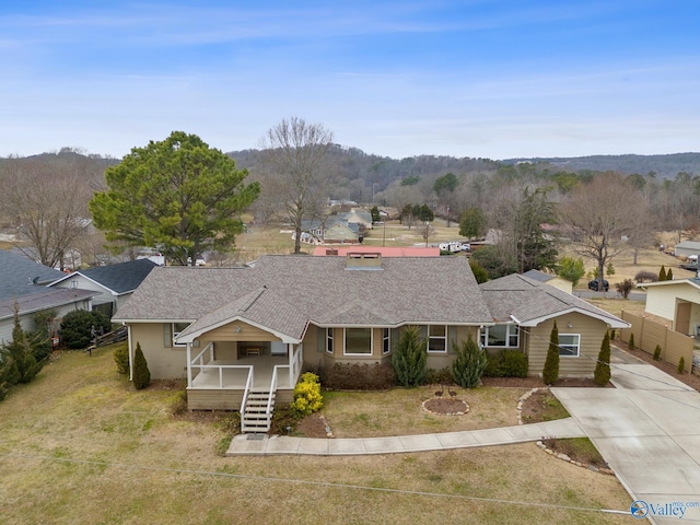 view of front of house with a porch and a front yard