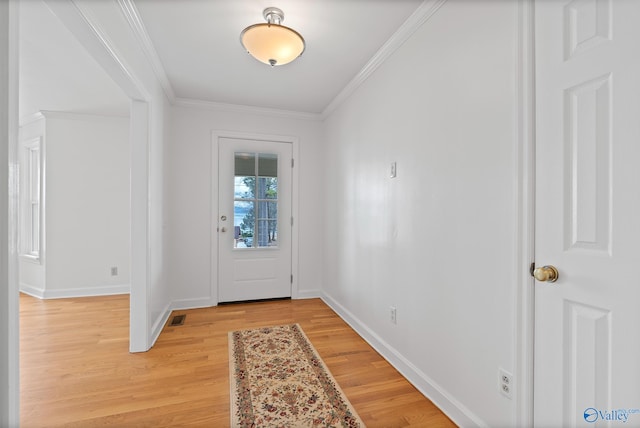 doorway to outside featuring crown molding and hardwood / wood-style flooring