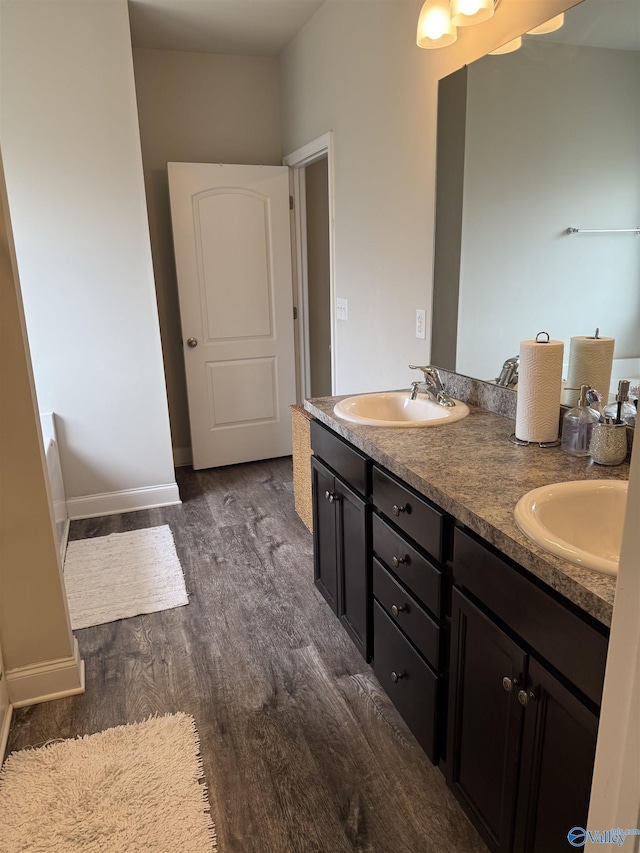 115 Richard Rd NE, Huntsville, AL 35811 - bathroom featuring double vanity, a sink, baseboards, and wood finished floors