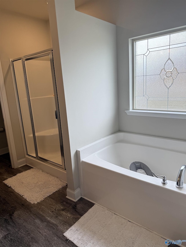 115 Richard Rd NE, Huntsville, AL 35811 - bathroom featuring a bath, wood finished floors, and a shower stall